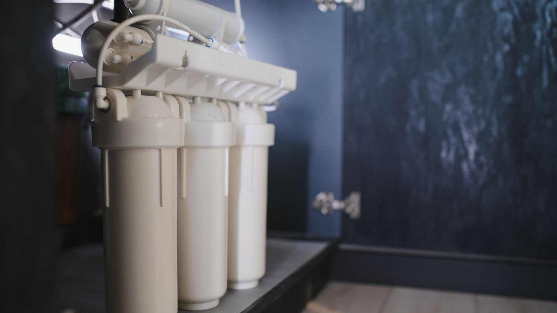 Multi-stage water filtration system with white cylindrical filters